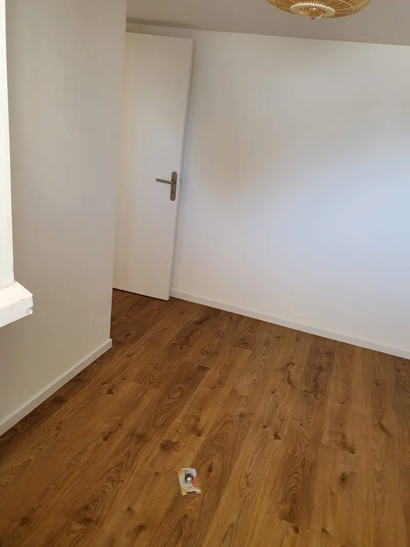Pièce repeinte avec sol stratifié effet chêne